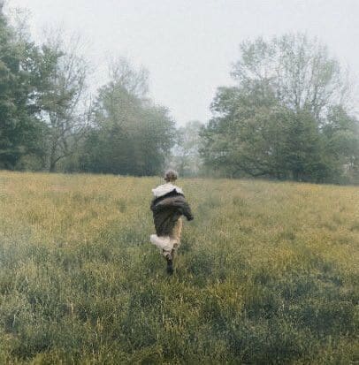 image of taylor swift running through a meadow