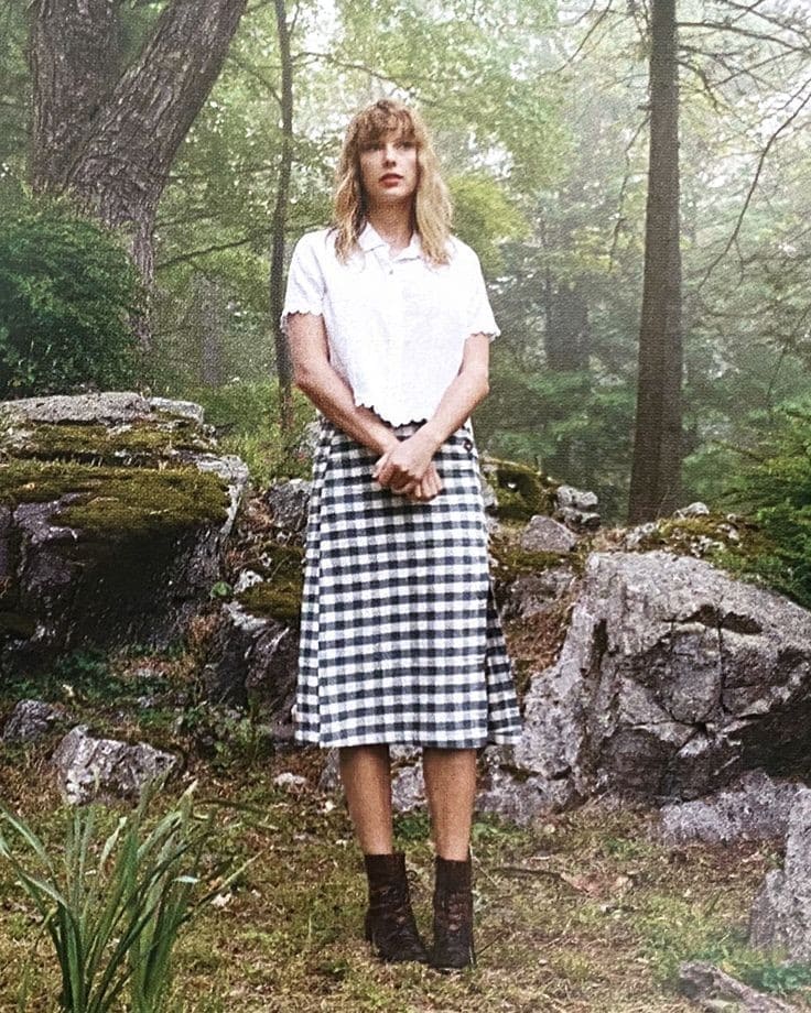 taylor swift standing in a forest
